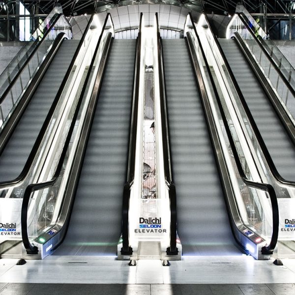 An interior shot of a building with escalators